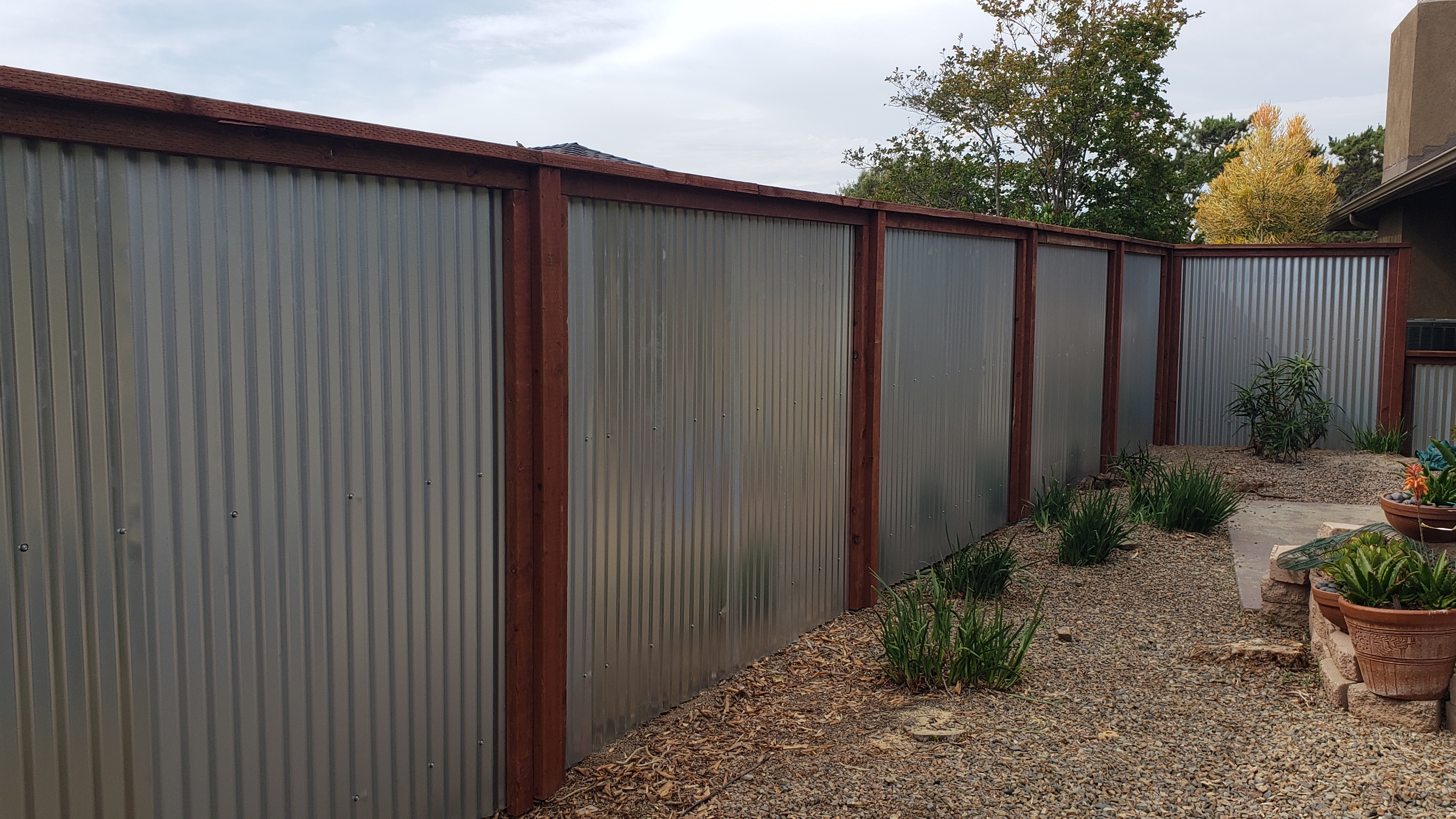 Corrugated metal fence