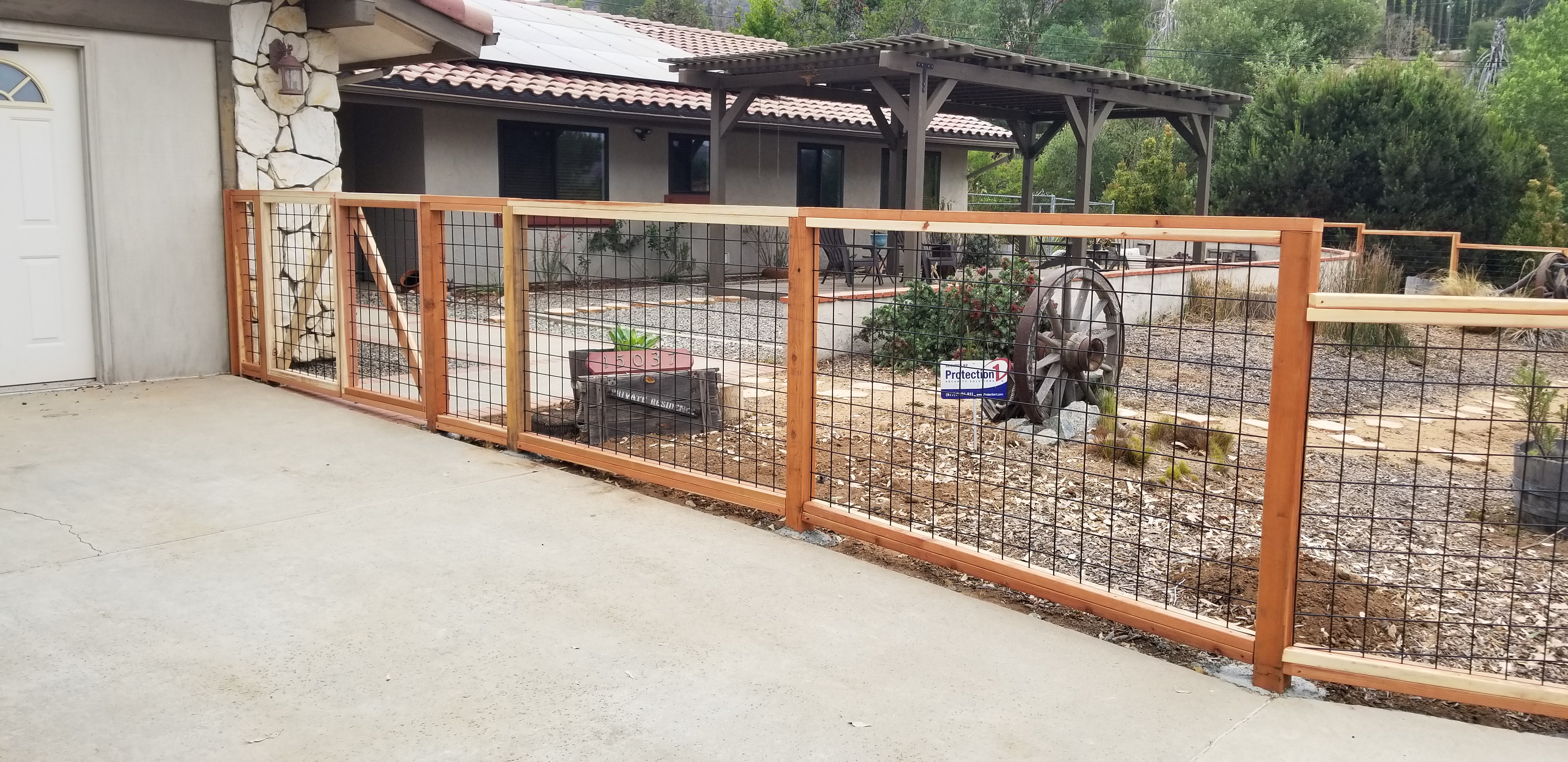 Hog wire fence with redwood frame by Fence Craft